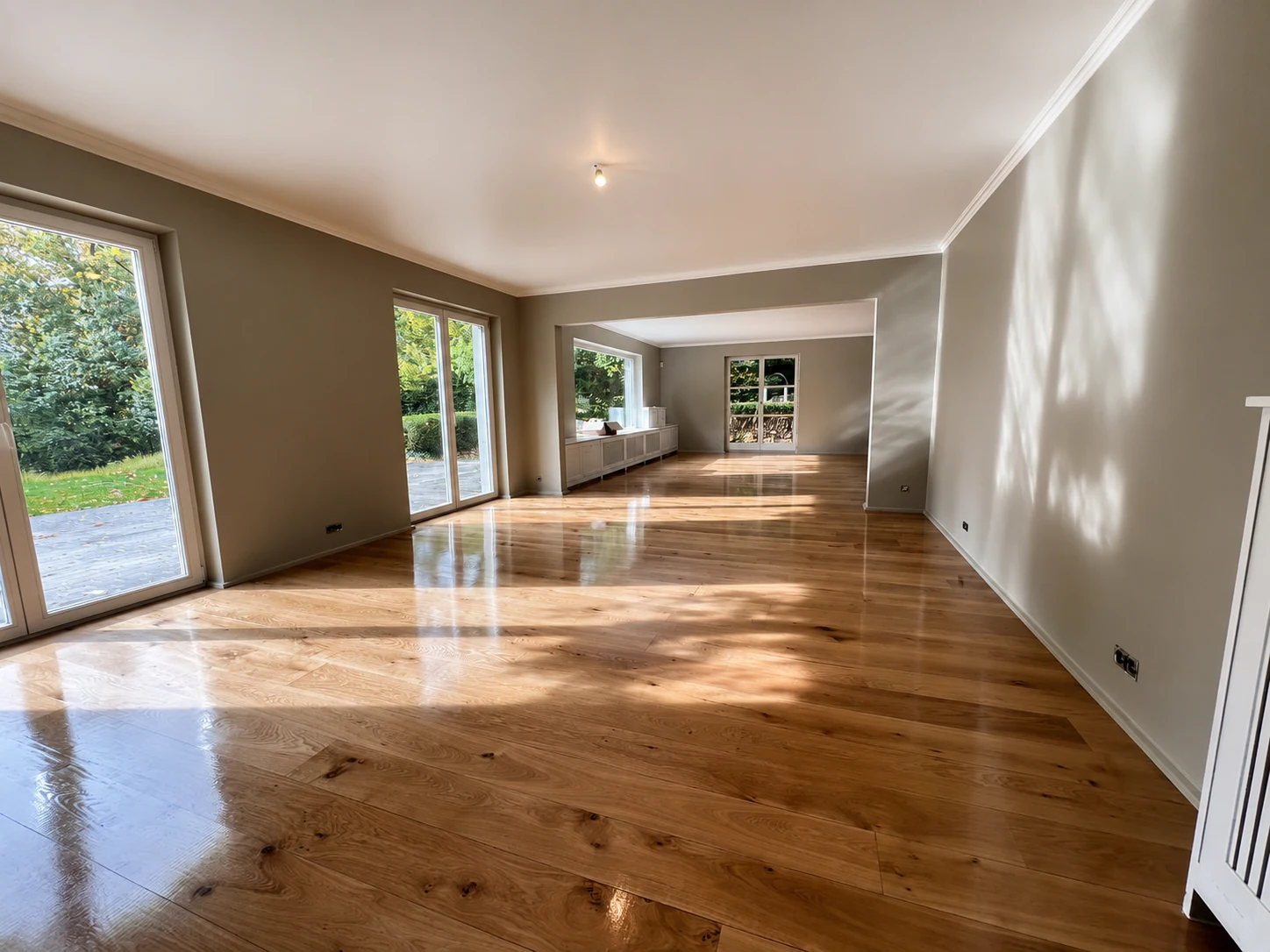 Bright renovated living space with wooden flooring